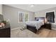 Cozy bedroom with wood-look flooring, accent rug, natural light, and a comfortable bed at 3934 North Fraser St., Georgetown, SC 29440