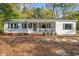 Charming single story home with white siding, green shutters, and a welcoming front porch at 3934 North Fraser St., Georgetown, SC 29440