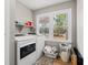 Functional laundry room with modern washer and dryer, storage shelves, and a window for natural light at 3934 North Fraser St., Georgetown, SC 29440