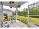 Relaxing screened-in porch overlooking a serene pond and lush greenery, perfect for outdoor enjoyment at 40 Parkside Dr., Pawleys Island, SC 29585