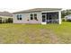 The backyard features green grass, decorative flowers, and screened-in porch at 40 Parkside Dr., Pawleys Island, SC 29585