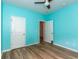 Bright blue bedroom with modern ceiling fan, wood-look floors, and ample space at 40 Parkside Dr., Pawleys Island, SC 29585
