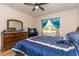 This bedroom features a ceiling fan, wood-look flooring, and a large bed at 40 Parkside Dr., Pawleys Island, SC 29585