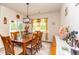 Warm dining room with a wooden table and chairs, complemented by natural light from the adjacent window at 40 Parkside Dr., Pawleys Island, SC 29585
