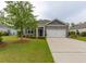 Charming single-story home with well-manicured lawn, complemented by a two-car garage and inviting curb appeal at 40 Parkside Dr., Pawleys Island, SC 29585