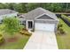 Charming single-story home featuring a brick facade, well-manicured lawn, and an attached two-car garage at 40 Parkside Dr., Pawleys Island, SC 29585