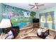 Comfortable living room featuring a vibrant mural, plush seating, and ample natural light through the window at 40 Parkside Dr., Pawleys Island, SC 29585