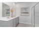Modern bathroom featuring a dual vanity, decorative mirror and glass-enclosed shower at 400 Rookroost Circle, Conway, SC 29526