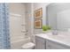 Bathroom featuring grey cabinets, a shower, and a large mirror with green decor at 400 Rookroost Circle, Conway, SC 29526