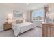 Bright bedroom featuring a large window, neutral decor and a comfortable queen-sized bed at 400 Rookroost Circle, Conway, SC 29526