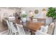 Elegant dining space with a large wooden table, white chairs, and stylish decor connecting to the kitchen at 400 Rookroost Circle, Conway, SC 29526