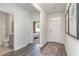 Bright entryway showcasing wood-look floors, white walls, and access to a bedroom and bathroom at 400 Rookroost Circle, Conway, SC 29526