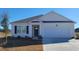 Charming single-story home featuring a two-car garage, manicured lawn, and a welcoming entrance at 400 Rookroost Circle, Conway, SC 29526