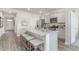 Well-lit kitchen with stainless steel appliances, gray cabinets, granite countertops, and barstool seating at 400 Rookroost Circle, Conway, SC 29526