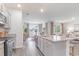 Open-concept kitchen flowing into the dining and living areas, featuring granite countertops and modern finishes at 400 Rookroost Circle, Conway, SC 29526