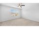 Bright bedroom featuring a window view, a ceiling fan, and neutral carpet at 4009 Alvina Way, Myrtle Beach, SC 29579