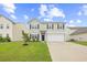 Charming two-story home with manicured lawn, black shutters, and attached garage at 4009 Alvina Way, Myrtle Beach, SC 29579