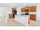 Open kitchen boasts granite countertops, dark wood cabinetry, stainless steel appliances, and a large island at 4009 Alvina Way, Myrtle Beach, SC 29579