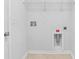 A laundry room with white walls, beige tile floor, utility connections, and wire rack shelving at 4009 Alvina Way, Myrtle Beach, SC 29579
