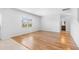 Spacious living room featuring sleek hardwood floors, a bright window, and neutral color scheme at 4009 Alvina Way, Myrtle Beach, SC 29579