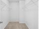 Walk-in closet with shelves and neutral carpet, offering ample storage space at 4009 Alvina Way, Myrtle Beach, SC 29579
