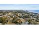 Stunning aerial view of a coastal neighborhood with a pond, lush trees, and the ocean in the background at 409 14Th Ave. S, North Myrtle Beach, SC 29582