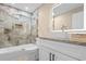 Modern bathroom features shower and tub combination, and marble counter top at 409 14Th Ave. S, North Myrtle Beach, SC 29582