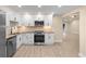 Modern kitchen features stainless steel appliances, granite countertops, and white cabinetry at 409 14Th Ave. S, North Myrtle Beach, SC 29582