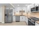 Updated kitchen featuring stainless appliances, stone backsplash, and shaker cabinets at 409 14Th Ave. S, North Myrtle Beach, SC 29582