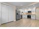 Modern kitchen with stainless steel appliances, stone countertops, and white cabinets with pantry at 409 14Th Ave. S, North Myrtle Beach, SC 29582