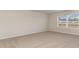 Carpeted bedroom with large window offering natural light at 411 Acosta Circle, Conway, SC 29527