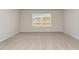 Bright bedroom features neutral walls, plush carpeting, and a window offering natural light at 411 Acosta Circle, Conway, SC 29527