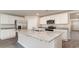 Kitchen featuring stainless steel appliances, granite countertops, large kitchen island, and white cabinetry at 411 Acosta Circle, Conway, SC 29527