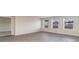 Bright living room with three windows, neutral paint, and stylish wood-look floors; adjacent to doorway at 411 Acosta Circle, Conway, SC 29527