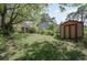 The backyard has well-maintained lawn, storage sheds, mature trees, and lush landscaping at 4300 Cross Cut Trail, Myrtle Beach, SC 29579