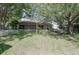 The sprawling backyard boasts mature trees and a quaint white picket fence, creating a private and charming outdoor space at 4300 Cross Cut Trail, Myrtle Beach, SC 29579