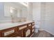 This light-filled bathroom features a wood vanity and hard surface floors at 4300 Cross Cut Trail, Myrtle Beach, SC 29579
