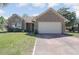 Charming brick home featuring a two-car garage and a well-maintained front yard with flowering plants at 4300 Cross Cut Trail, Myrtle Beach, SC 29579