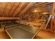 Unfinished attic space showcasing exposed wood beams and ping pong table at 4535 Carriage Run Circle, Murrells Inlet, SC 29576