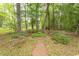 Lush backyard garden with a brick pathway and tranquil water feature at 4535 Carriage Run Circle, Murrells Inlet, SC 29576