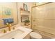 Neat bathroom with gold fixtures, decorative wall art, and bathtub with glass door at 4535 Carriage Run Circle, Murrells Inlet, SC 29576