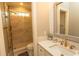 Bright bathroom featuring marble shower, glass door and vanity with gold faucet at 4535 Carriage Run Circle, Murrells Inlet, SC 29576
