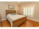 Cozy bedroom features a wooden bed frame, shutters on the window, and hardwood floors at 4535 Carriage Run Circle, Murrells Inlet, SC 29576
