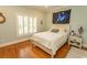Cozy bedroom with hardwood floors, shutters, and a queen-sized bed with a decorative pillow at 4535 Carriage Run Circle, Murrells Inlet, SC 29576