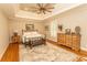 Spacious primary bedroom boasts tray ceiling, hardwood floors, and neutral paint at 4535 Carriage Run Circle, Murrells Inlet, SC 29576