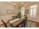 Elegant dining room featuring wainscoting, shutters, and a stylish chandelier for formal gatherings at 4535 Carriage Run Circle, Murrells Inlet, SC 29576