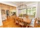 Dining room featuring a wood table with seating for six, hardwood floors, and a modern chandelier at 4535 Carriage Run Circle, Murrells Inlet, SC 29576