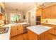 Open kitchen with custom cabinets, stainless steel appliances, island with quartz countertops, and hardwood floors at 4535 Carriage Run Circle, Murrells Inlet, SC 29576
