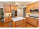 Kitchen with custom cabinets, stainless steel refrigerator, and a center island featuring quartz countertops at 4535 Carriage Run Circle, Murrells Inlet, SC 29576