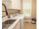Well-equipped laundry room with stainless steel sink, washer, dryer and window at 4535 Carriage Run Circle, Murrells Inlet, SC 29576